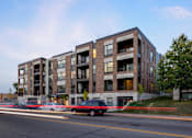 Thumbnail 13 of 31 - Exterior view of Elements on Linden Hill, three cars parked on near street entrance
