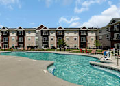 Thumbnail 10 of 24 - a swimming pool with an apartment building in the background