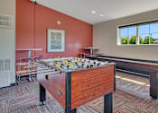 Thumbnail 15 of 24 - a games room with a foosball table and a bar