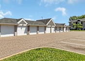 Thumbnail 21 of 24 - a house with white garage doors and a driveway in front of it