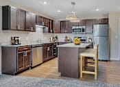 Thumbnail 5 of 24 - a kitchen with stainless steel appliances and wooden cabinets