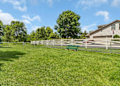 Thumbnail 11 of 11 - a fenced in backyard with a white fence and benches