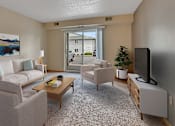 Thumbnail 5 of 11 - a living room with a couch and chairs and a tv