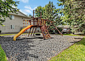 Thumbnail 6 of 11 - a swing set with a yellow slide in a backyard