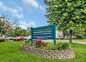 Thumbnail 4 of 11 - a sign sits in the grass in front of a building