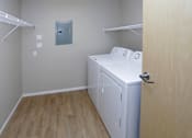 Thumbnail 6 of 9 - In unit washer and dryer located in the walk-in closet with storage shelves and hanging space.