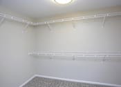 Thumbnail 5 of 9 - Inside of spacious walk in closet with plenty of shelves and hanging space.