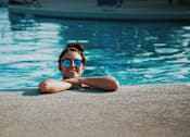 Thumbnail 15 of 23 - a young boy in a swimming pool