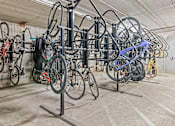 Thumbnail 35 of 40 - a row of bikes hanging on a rack in a building