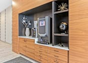 Thumbnail 38 of 40 - a lobby with a wood paneled wall with a coffee machine