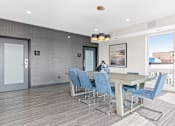 Thumbnail 14 of 40 - a dining room with a table and chairs