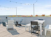 Thumbnail 15 of 40 - the patio on the top of the building has tables and chairs and views of the