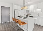 Thumbnail 2 of 40 - a kitchen with white cabinets and a white counter top