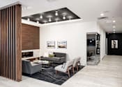 Thumbnail 37 of 40 - Cozy and sleek fireplace lounge in the lobby with white walls.