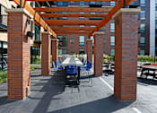 Thumbnail 23 of 40 - Outdoor courtyard complete with a variety of tables and a pergola.
