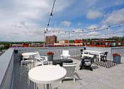 Thumbnail 16 of 40 - Stunning rooftop with string lights, casual dining area, and lounge seating.