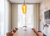 Thumbnail 45 of 58 - a meeting room with a long wooden table and orange chairs