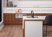 Thumbnail 51 of 58 - a kitchen with white countertops and wooden cabinets