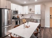 Thumbnail 8 of 58 - a kitchen with white cabinets and stainless steel appliances