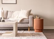 Thumbnail 11 of 58 - a living room with a sofa and side table
