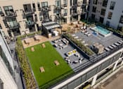 Thumbnail 32 of 58 - an aerial view of an apartment complex with a lawn and a pool