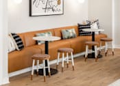 Thumbnail 22 of 58 - a living room with an orange couch and stools