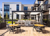 Thumbnail 41 of 58 - a patio with yellow tables and chairs