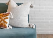 Thumbnail 23 of 58 - a blue chair with a white cushion and a brown and white pillow on top of it