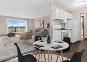 Thumbnail 2 of 34 - A modern kitchen with white appliances and a dining table set for two.