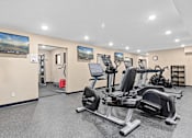 Thumbnail 23 of 34 - A gym with a row of exercise bikes.
