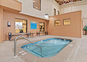 Thumbnail 22 of 34 - A small indoor pool with a metal railing.
