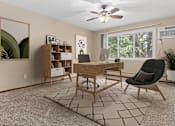 Thumbnail 9 of 34 - A room with a desk, chair, and a rug.
