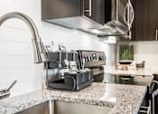 Thumbnail 3 of 42 - Close up of stainless steel sink and granite countertops