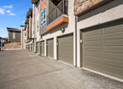 Thumbnail 37 of 42 - Outdoor private car garages with apartment balconies overhead
