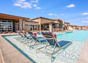 Thumbnail 15 of 42 - Outdoor pool with sun chairs in shallow end