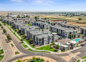 Thumbnail 40 of 42 - an aerial view of a city with apartment buildings and a highway