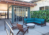 Thumbnail 20 of 42 - A patio with a sofa, chairs, and a table.