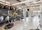 Thumbnail 25 of 42 - the interior of a gym with weights and racks of equipment