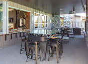 Thumbnail 32 of 42 - A patio with a table and chairs is shown.