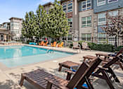 Thumbnail 16 of 42 - our apartments have a swimming pool with chairs and tables