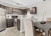 Thumbnail 1 of 29 - a kitchen and dining room with a table and chairs