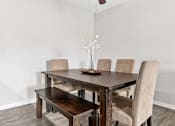 Thumbnail 4 of 29 - a dining room with a wooden table and chairs