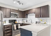 Thumbnail 2 of 29 - our apartments offer a modern kitchen with stainless steel appliances