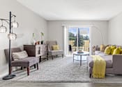 Thumbnail 3 of 29 - a living room with a couch and a chair