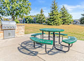 Thumbnail 26 of 29 - a patio with a picnic table and a barbecue grill