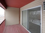 Thumbnail 13 of 24 - Outdoor private balcony with wood railing and sliding glass door leading inside