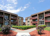 Thumbnail 20 of 24 - Exterior view of Plymouth Pointe building with split concrete walk path