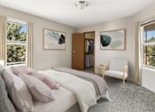 Thumbnail 7 of 11 - a bedroom with a bed and a chair and a closet