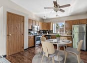 Thumbnail 1 of 11 - a kitchen and dining room with a table and chairs
