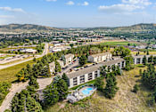 Thumbnail 10 of 11 - an aerial view of a building with trees and a city in the background